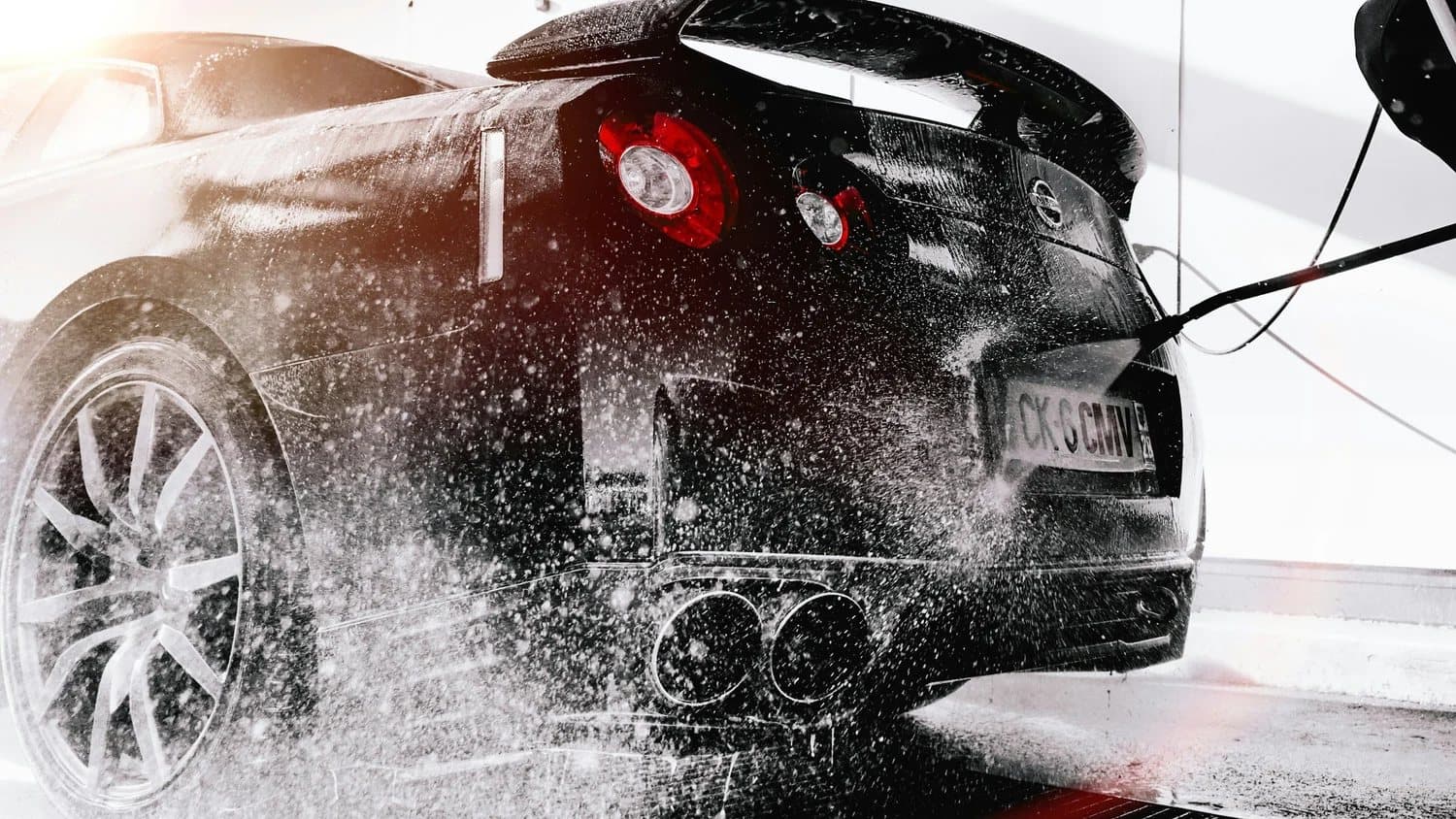 A car getting a fresh, high-pressure rinse at Clean Wash