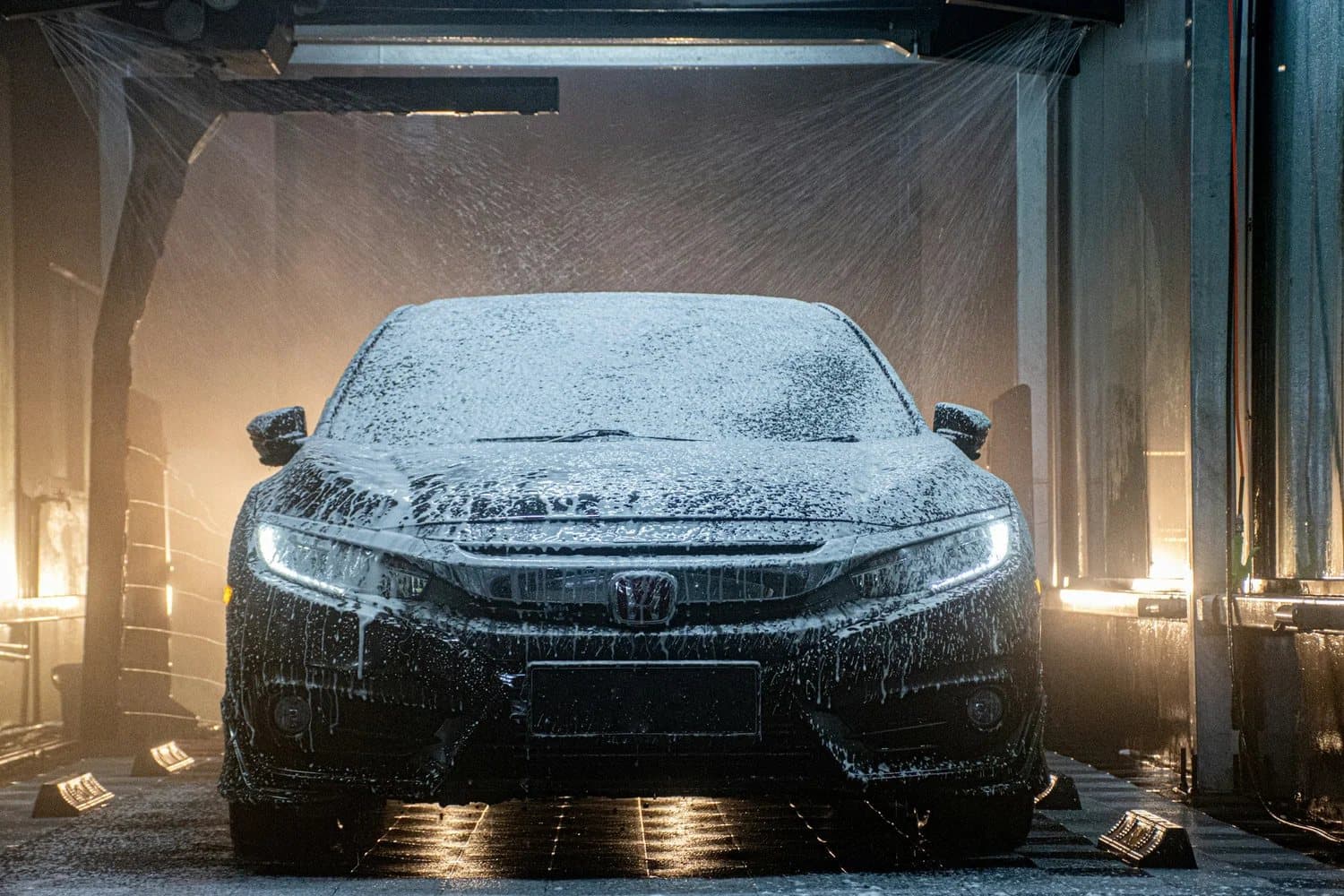 A car moving through the Clean Wash tunnel